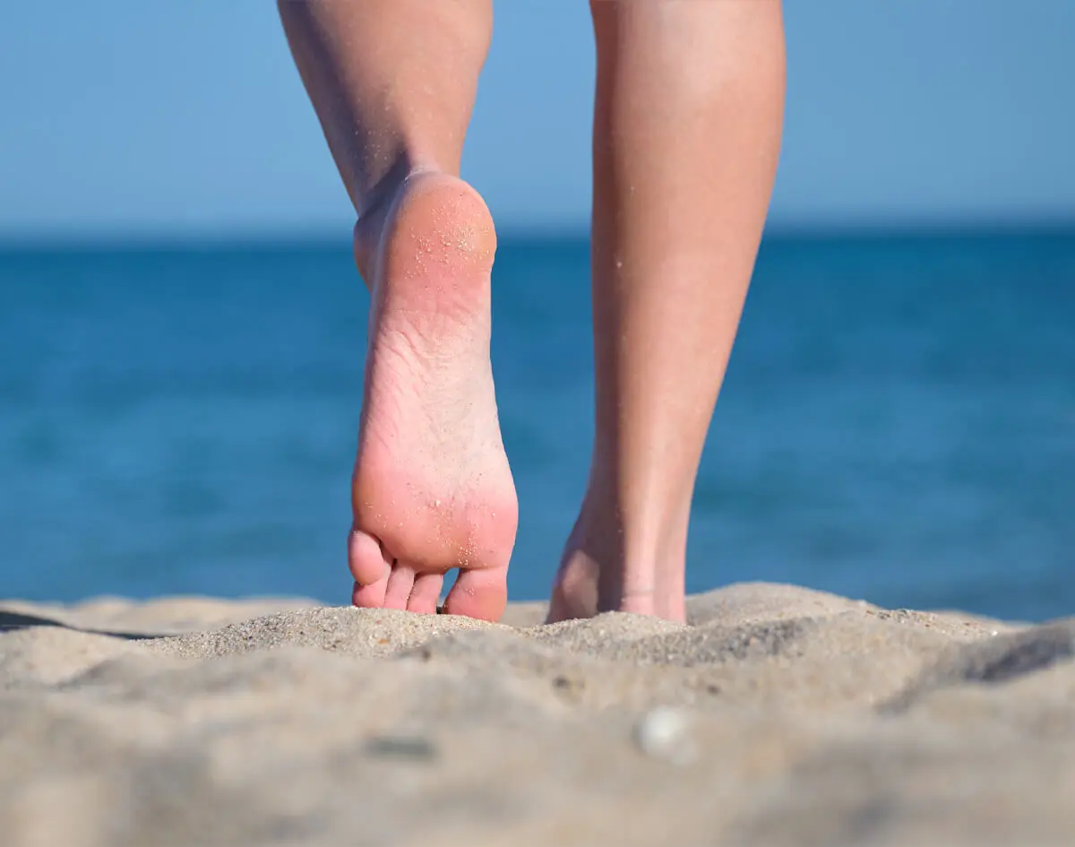 Healthy feet walking along a beach