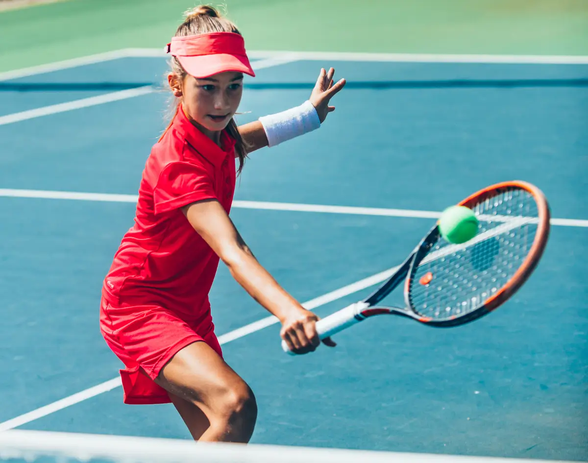 young female athlete tennis player hitting the ball